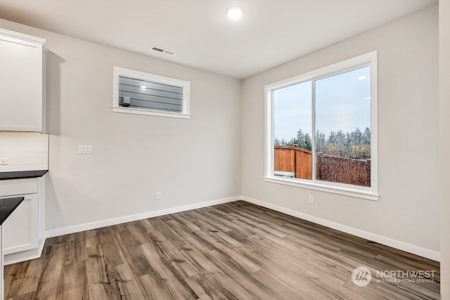 unfurnished dining area featuring hardwood / wood-style flooring