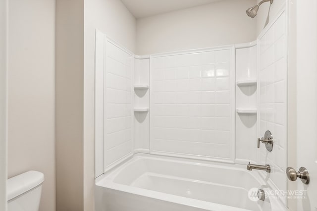 bathroom with shower / bathing tub combination and toilet