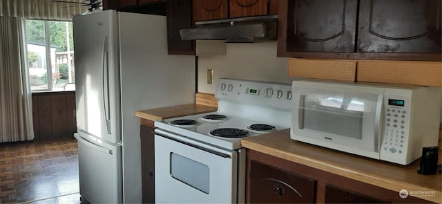 kitchen featuring dark parquet flooring, ceiling fan, dark brown cabinetry, and white appliances