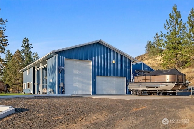 exterior space featuring a garage and an outdoor structure