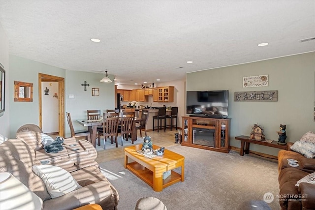 carpeted living room with a textured ceiling