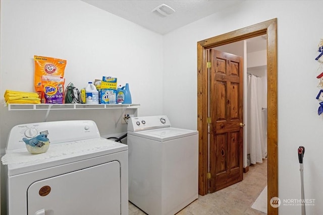 laundry area featuring washing machine and clothes dryer