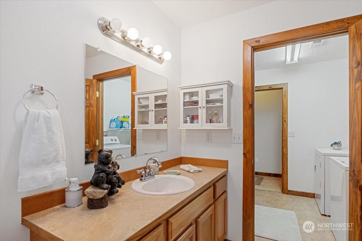 bathroom featuring independent washer and dryer and vanity