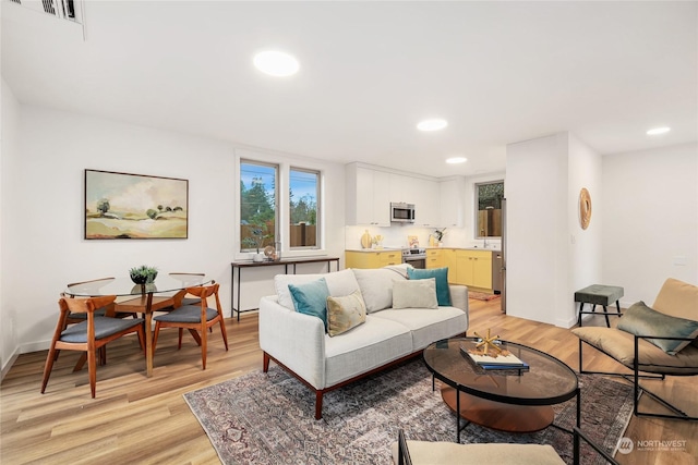 living room with light hardwood / wood-style flooring