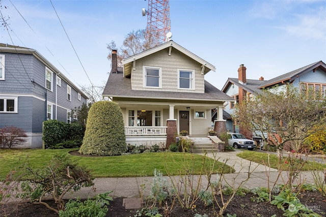 view of front facade featuring covered porch and a front yard