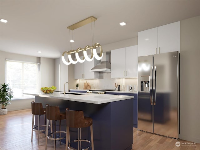 24328 Carter Rd Unit 2A, Bothell, WA 98012 - kitchen featuring stainless steel refrigerator with ice dispenser, light wood finished floors, a breakfast bar area, a center island with sink, and white cabinets