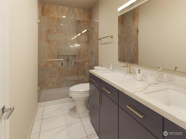 bathroom with a tile shower, vanity, toilet, and tile patterned floors