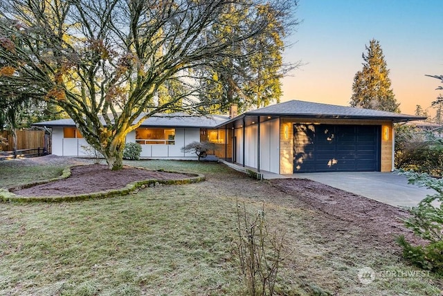 view of front of home with a lawn and a garage