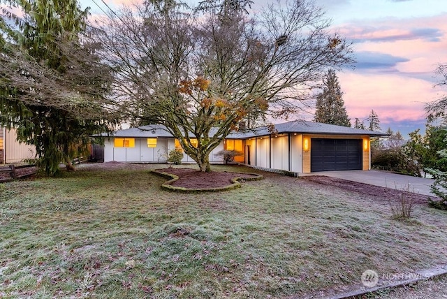 view of front facade with a yard and a garage