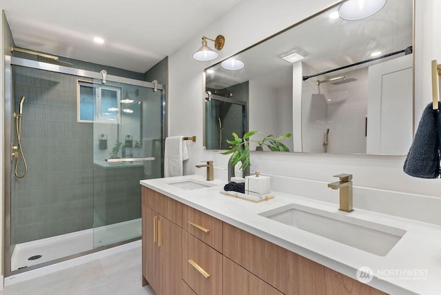 bathroom with vanity and a shower with door