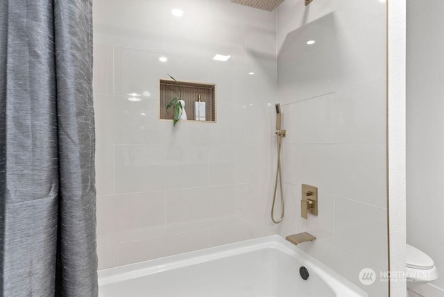 bathroom featuring shower / bath combination with curtain and toilet