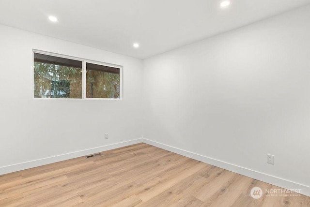 spare room featuring light wood-type flooring