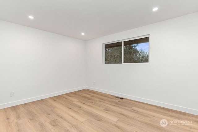 unfurnished room with light hardwood / wood-style flooring