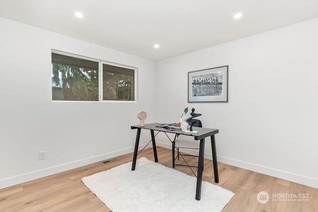 home office with hardwood / wood-style floors