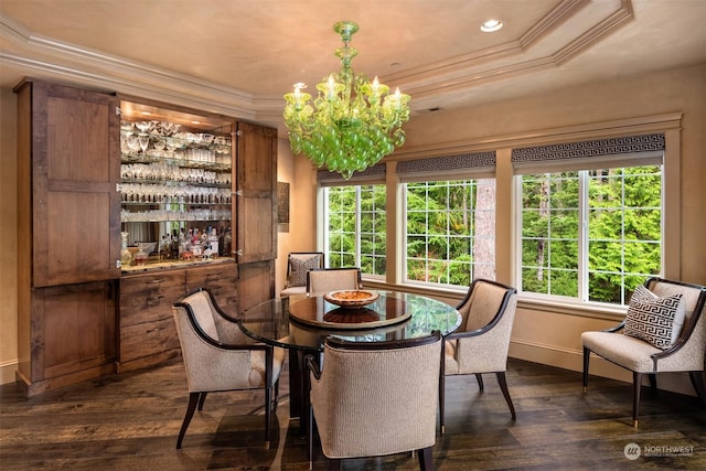 dining room with a chandelier, dark wood finished floors, crown molding, and a raised ceiling