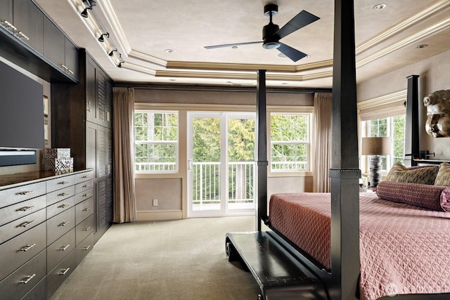 bedroom featuring access to exterior, a raised ceiling, light carpet, and ornamental molding