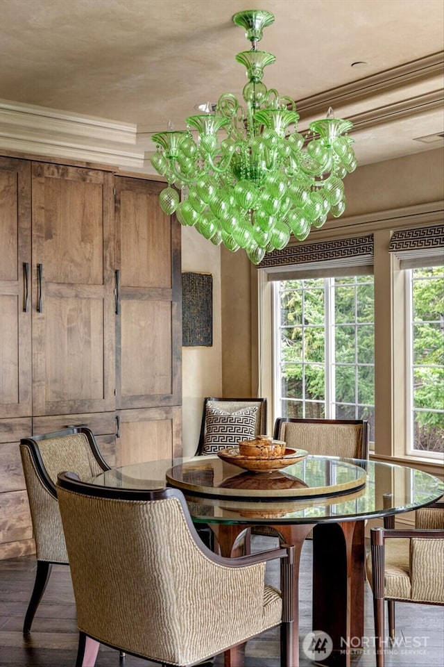 dining area featuring ornamental molding and wood finished floors