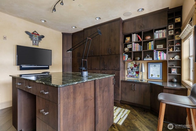 kitchen featuring dark stone counters, open shelves, dark wood-type flooring, and a center island