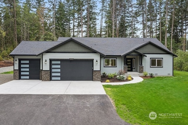 craftsman-style house with a garage and a front yard