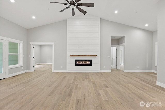 unfurnished living room featuring ceiling fan, a fireplace, high vaulted ceiling, and light hardwood / wood-style floors