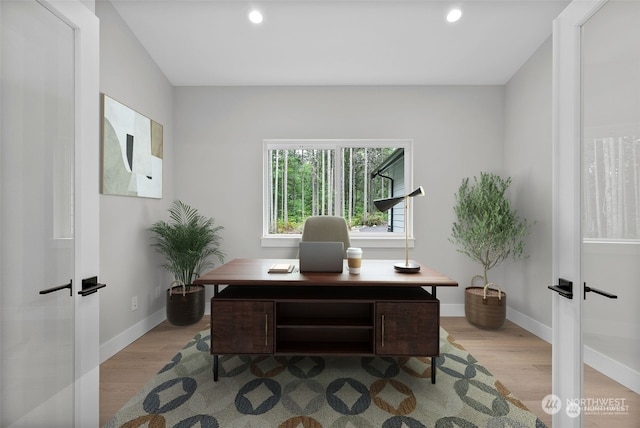 home office featuring french doors and light hardwood / wood-style floors