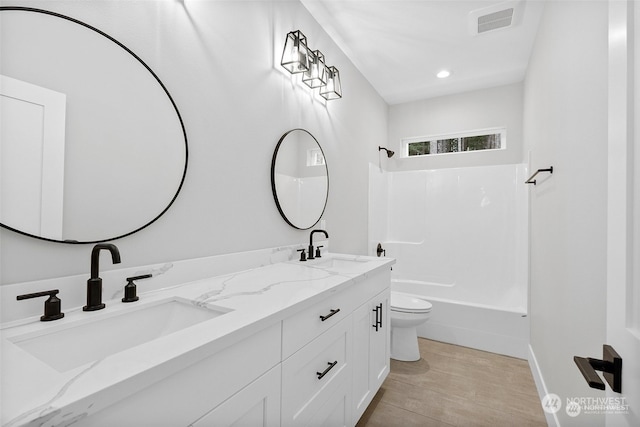 full bathroom featuring wood-type flooring, vanity, toilet, and tub / shower combination