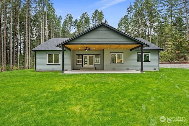 rear view of house with a yard, ceiling fan, and a patio area