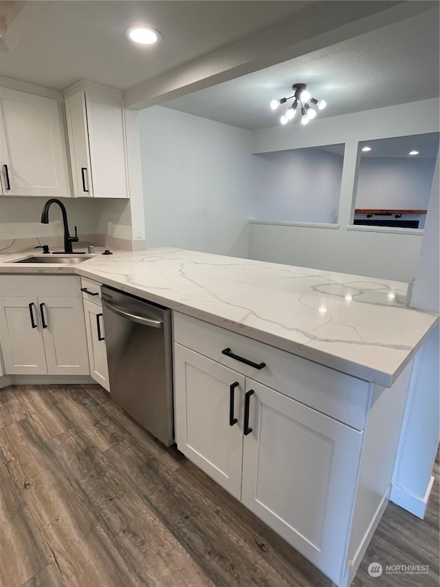 kitchen with white cabinets, dark hardwood / wood-style flooring, stainless steel dishwasher, and sink