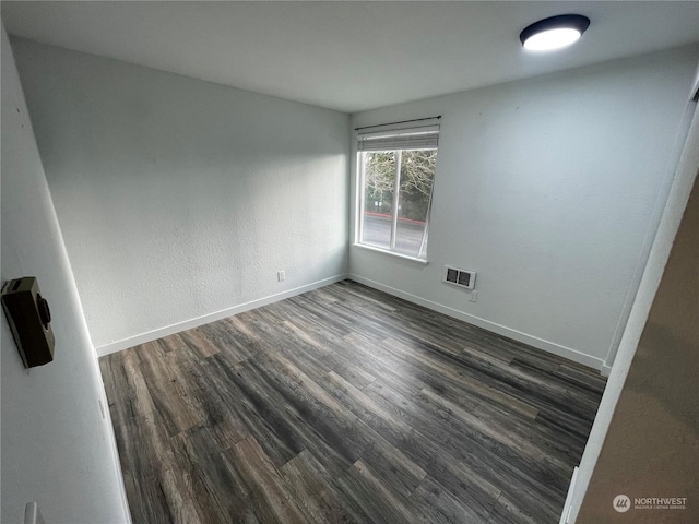 spare room featuring dark hardwood / wood-style floors