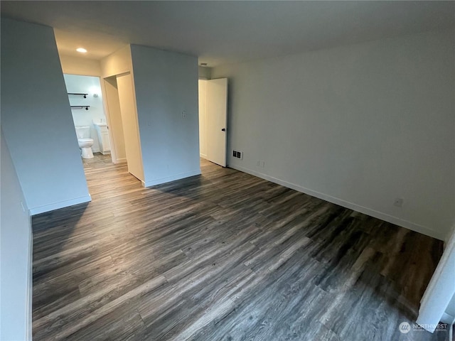 spare room with dark wood-type flooring