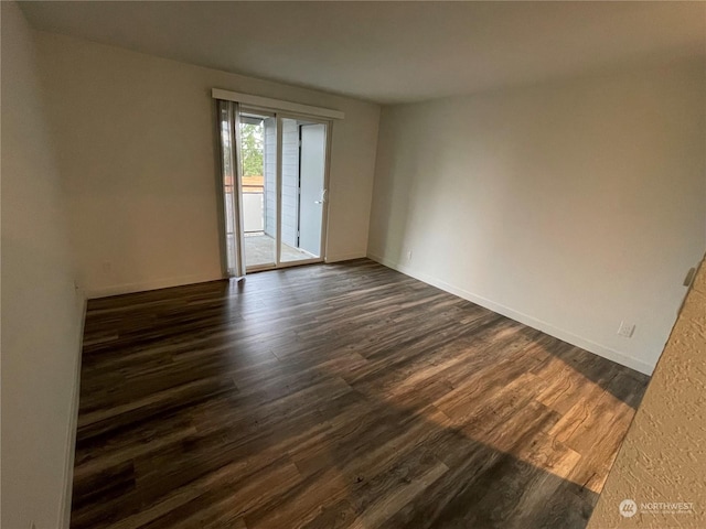 spare room featuring dark hardwood / wood-style floors