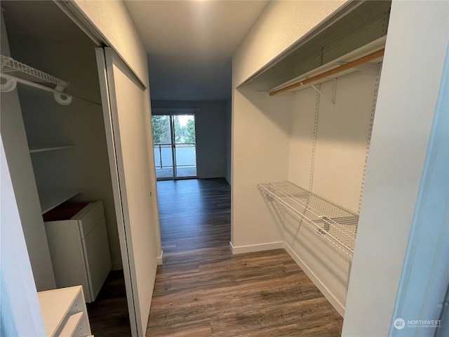 spacious closet with dark wood-type flooring