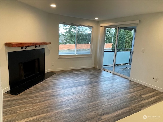 unfurnished living room featuring dark wood-type flooring