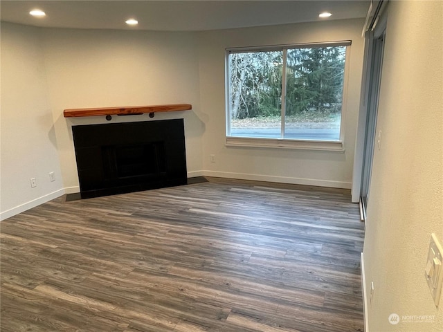 unfurnished living room with dark hardwood / wood-style floors