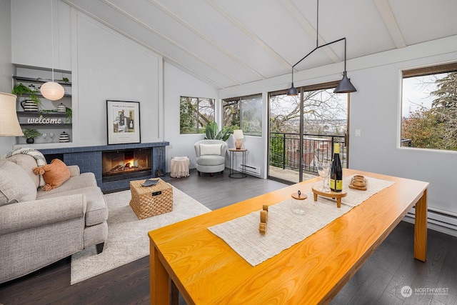 interior space featuring lofted ceiling with beams, a baseboard radiator, and a brick fireplace