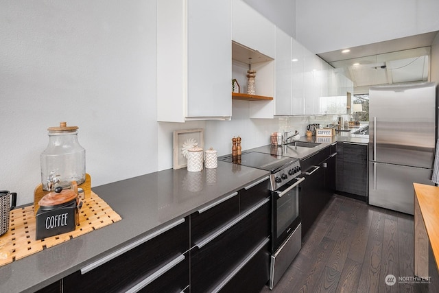 kitchen with dark hardwood / wood-style floors, white cabinetry, and stainless steel appliances