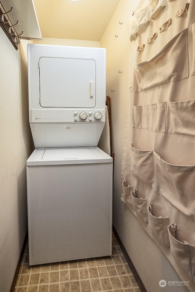 washroom with stacked washer / drying machine