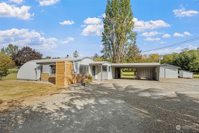 ranch-style house with a carport and a front lawn