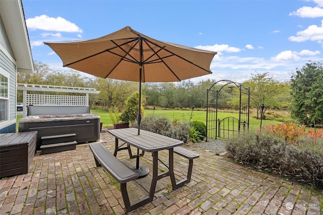 view of patio / terrace with a hot tub