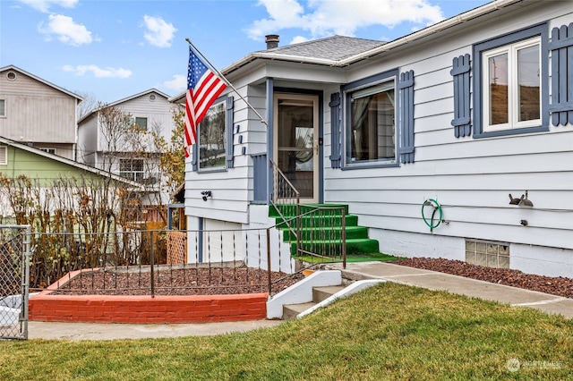 doorway to property featuring a yard