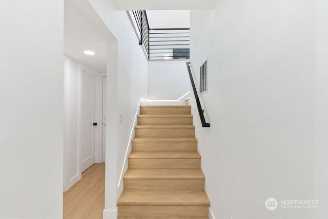 stairs with hardwood / wood-style floors