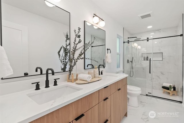 bathroom with walk in shower, vanity, and toilet