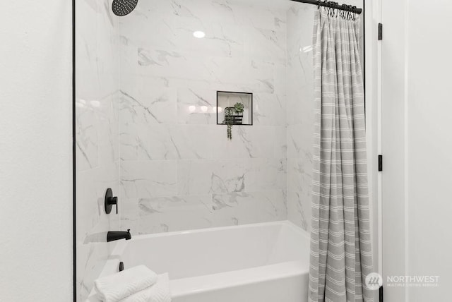 bathroom with shower / bath combo with shower curtain