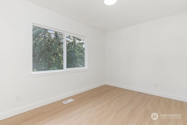 unfurnished room with light hardwood / wood-style floors