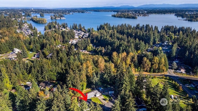 aerial view featuring a water and mountain view