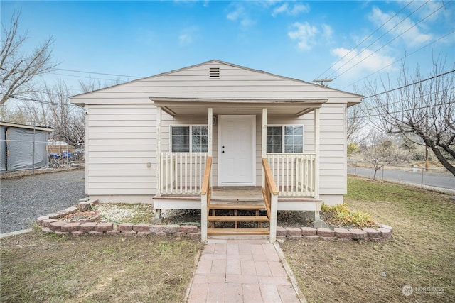 bungalow featuring a porch and a front yard