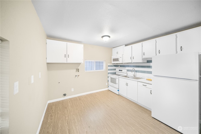 kitchen with white cabinetry, sink, white appliances, and light wood-type flooring