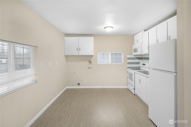 kitchen featuring white appliances, light hardwood / wood-style flooring, white cabinetry, and plenty of natural light