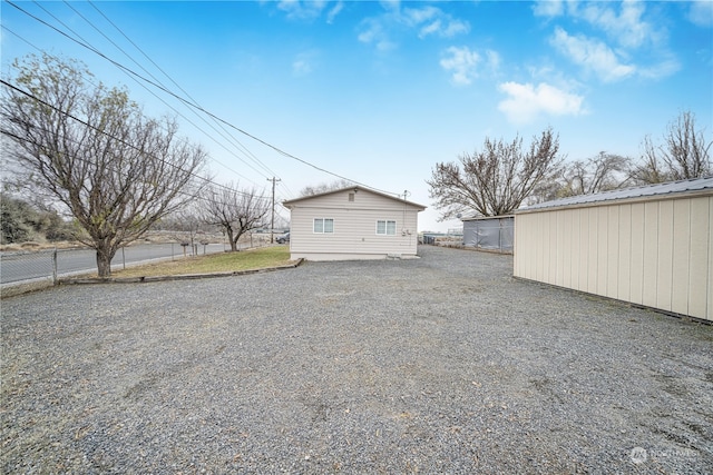 back of property with an outdoor structure