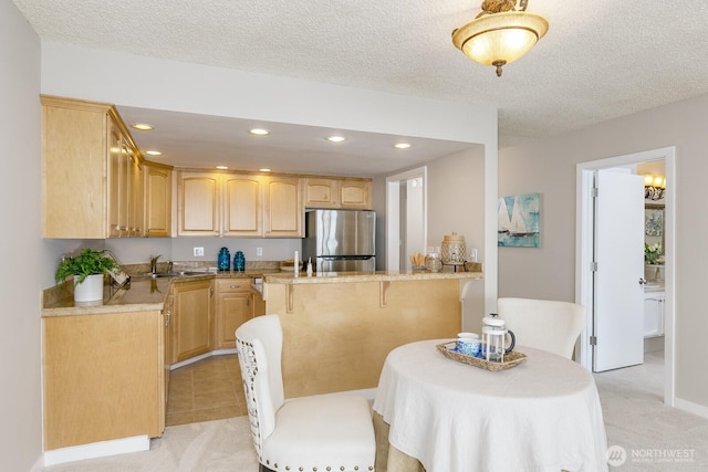 dining space featuring light carpet, recessed lighting, and a textured ceiling